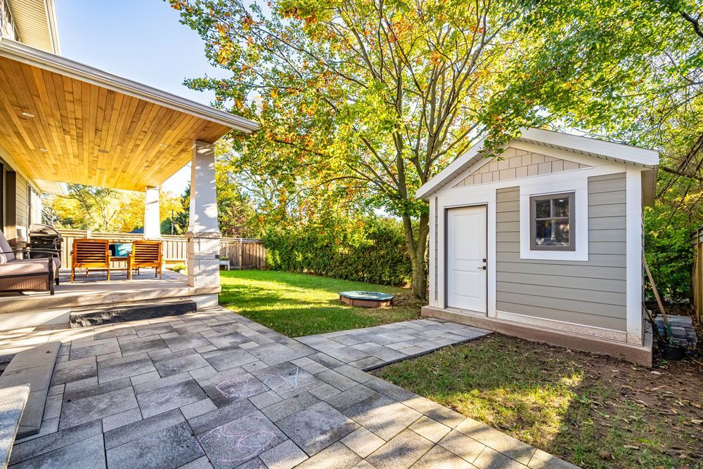 There is a shed in the backyard of a house on Tansley Drive by Oakroots Construction