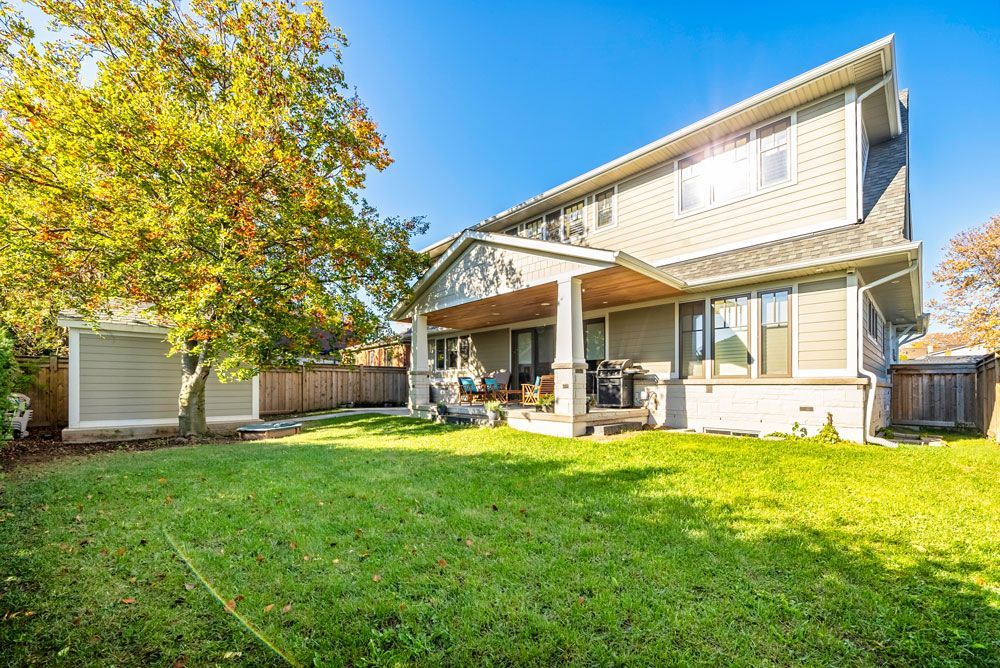 A large house with a large lawn in front of it on Tansley Drive by Oakroots Construction