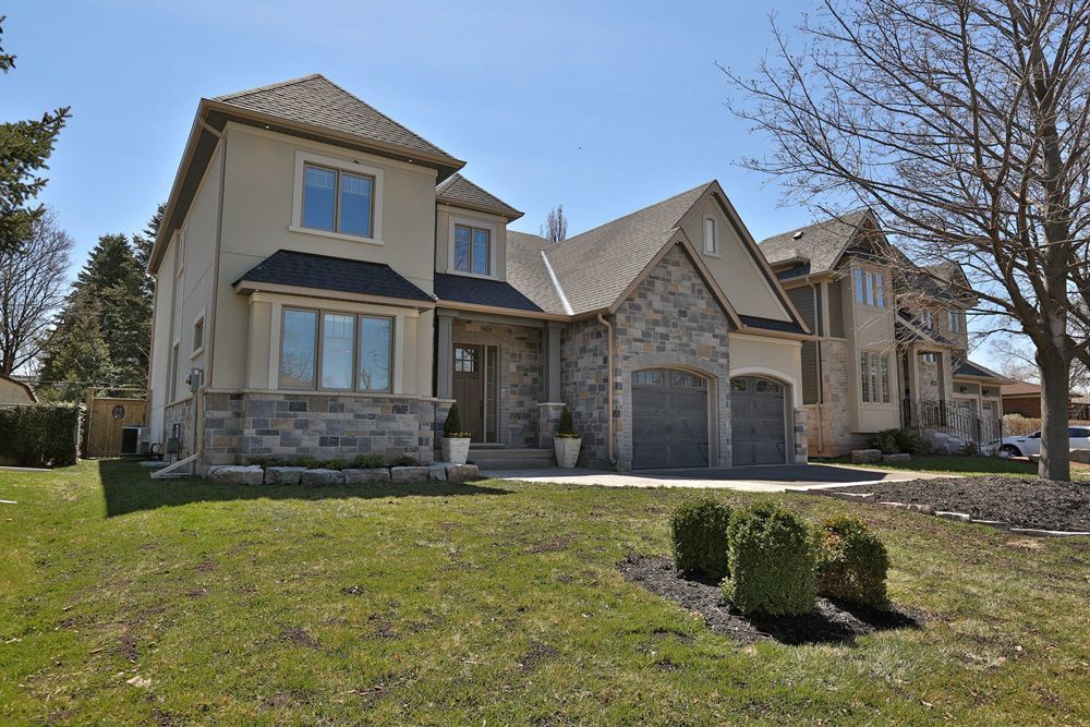 A large house with a large lawn in front of it.