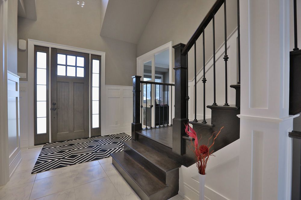 A hallway with stairs leading up to the second floor of a house.
