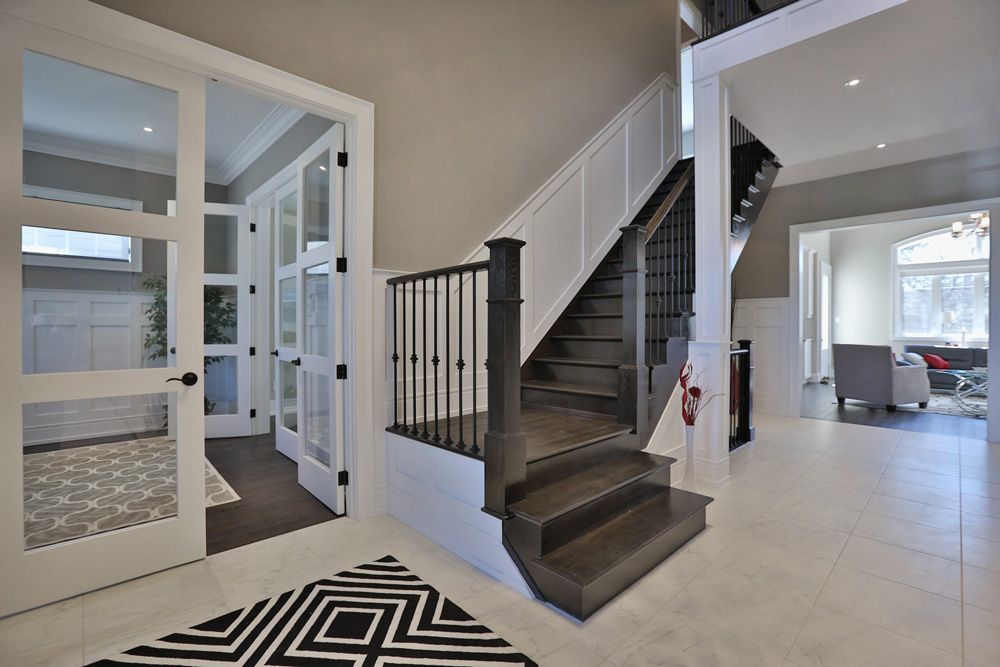 A staircase in a house with a rug on the floor