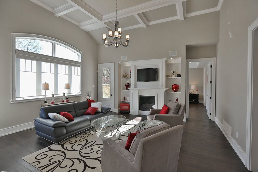 A living room with a couch , chairs , and a fireplace.