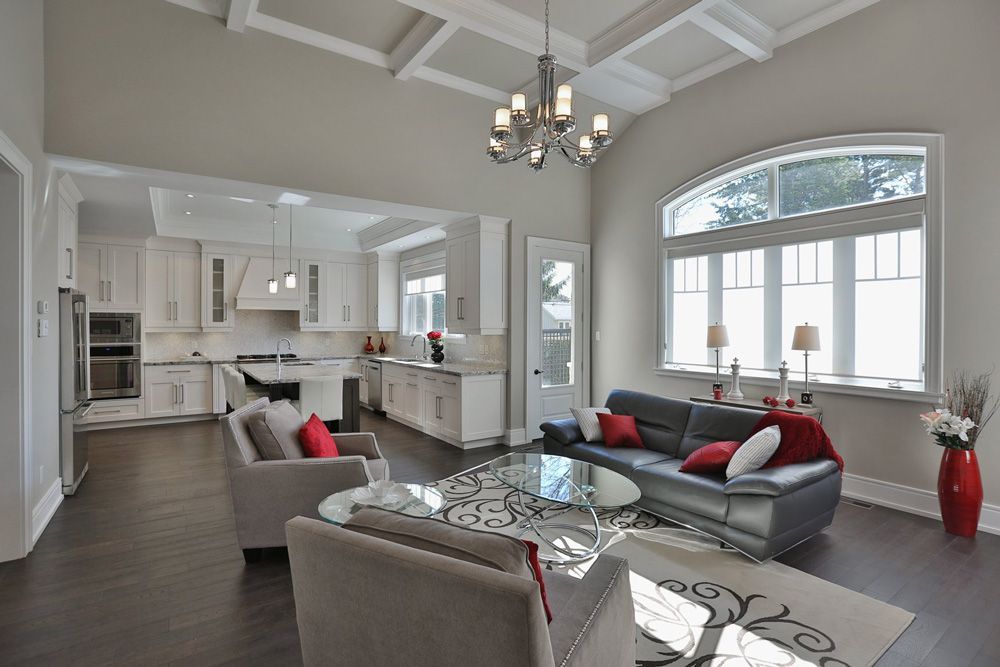 A living room with a couch and chairs and a chandelier