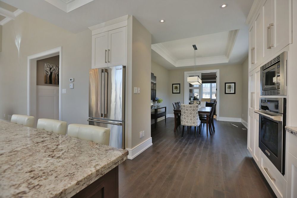 A kitchen with granite counter tops and stainless steel appliances