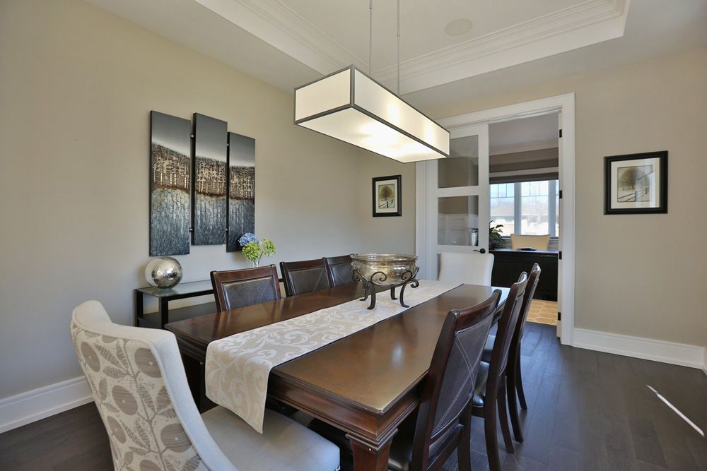 A dining room with a long wooden table and chairs