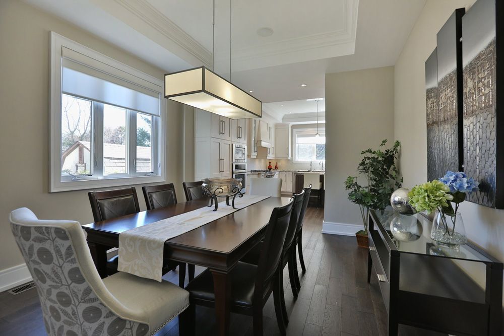A dining room with a long table and chairs