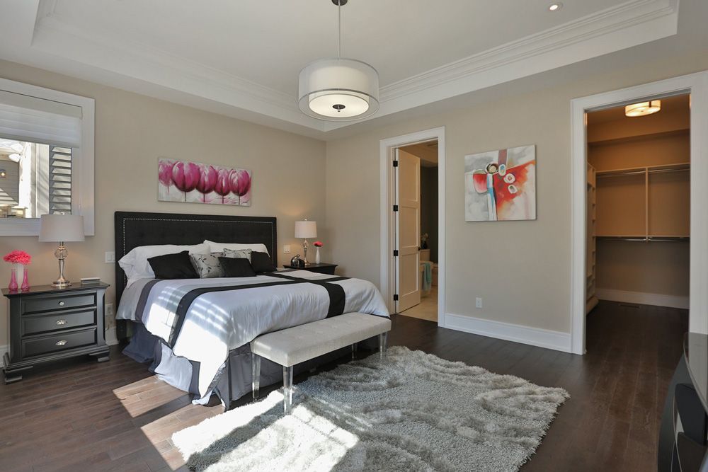 A bedroom with a large bed and a walk in closet.