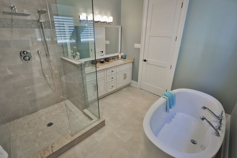 A bathroom with a tub and a walk in shower.