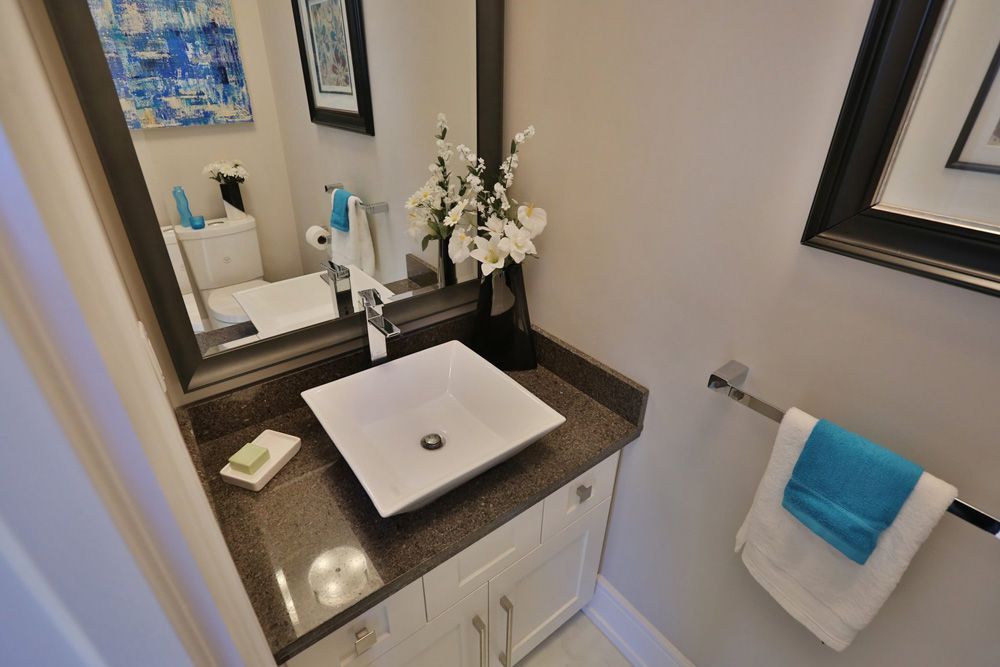 A bathroom with a square sink and a mirror