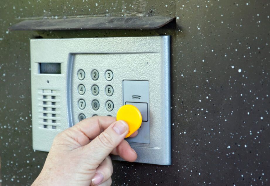 Hand Holding a Yellow Key Fob — Pacific Telephone & Data in Maitland, NSW