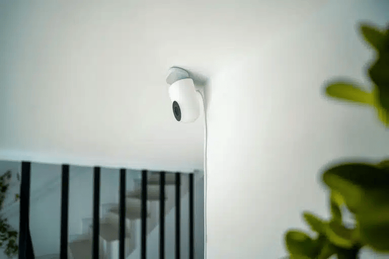 Security Camera Mounted on A White Ceiling and Wall — Pacific Telephone & Data In Cardiff, NSW