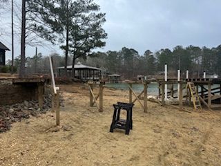 A wooden dock is being built next to a body of water.