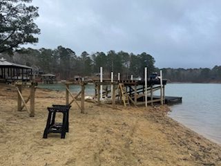 A dock is being built on the shore of a lake.