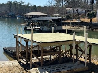 A wooden dock is being built on the shore of a lake.