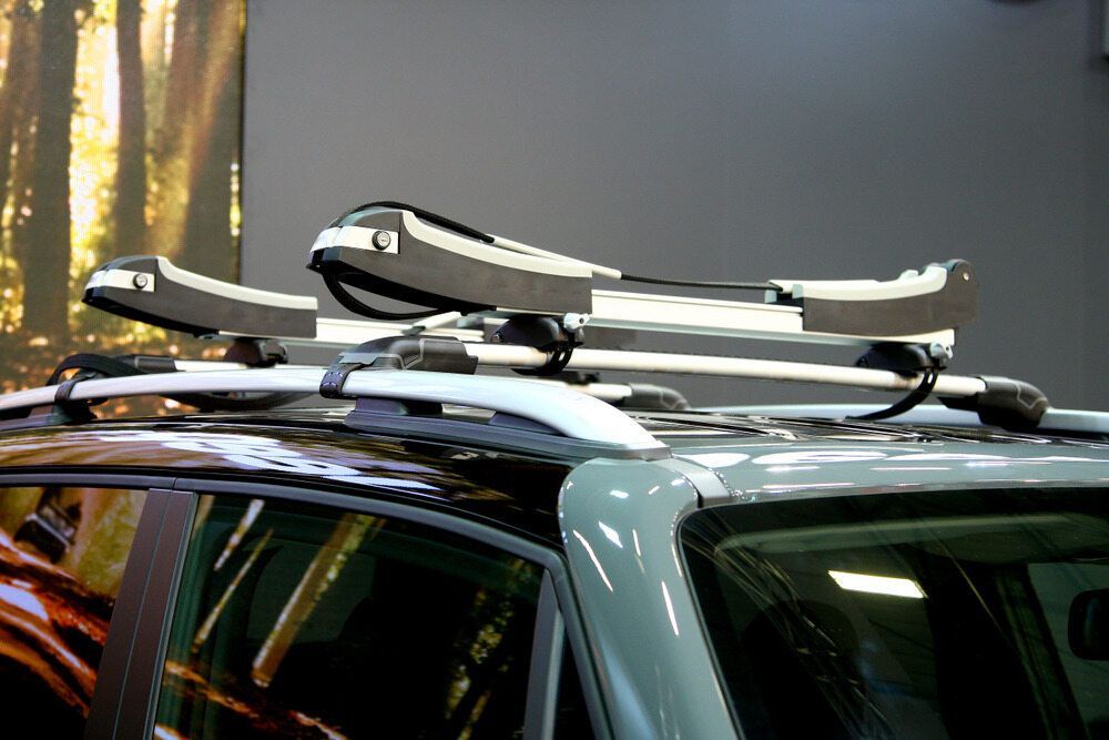A Car With Two Kayaks On The Roof Rack — Superior Machinery Maintenance In Ryan, QLD