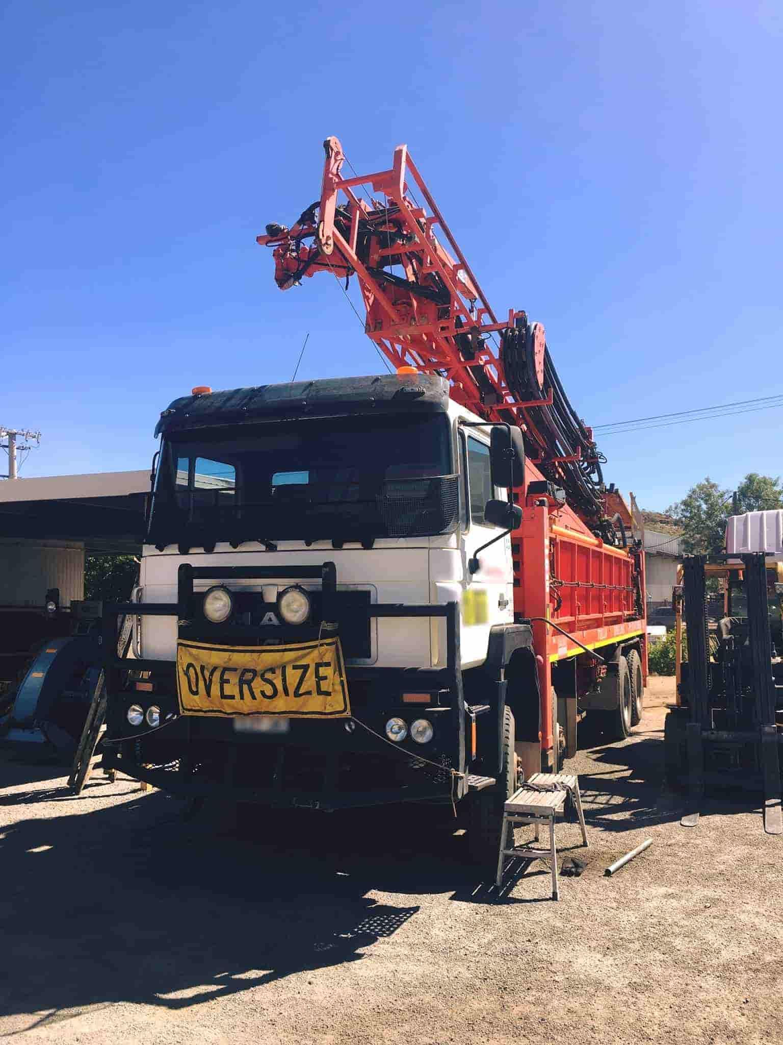An Oversize Truck Is Parked In A Gravel Lot — Superior Machinery Maintenance In Ryan, QLD