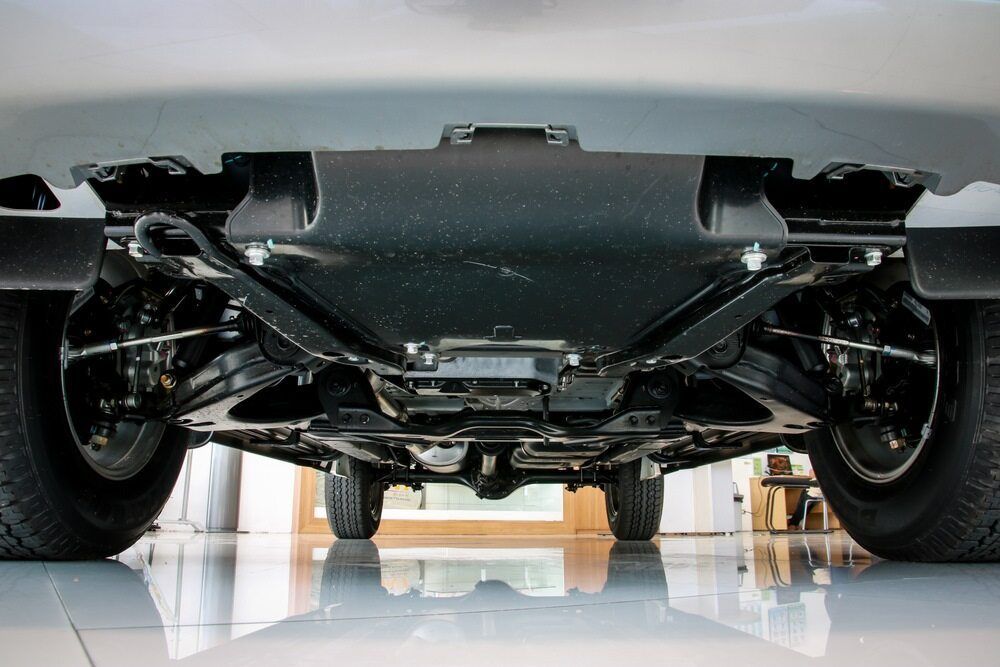 The Underside Of A Car Is Shown In A Garage — Superior Machinery Maintenance In Ryan, QLD