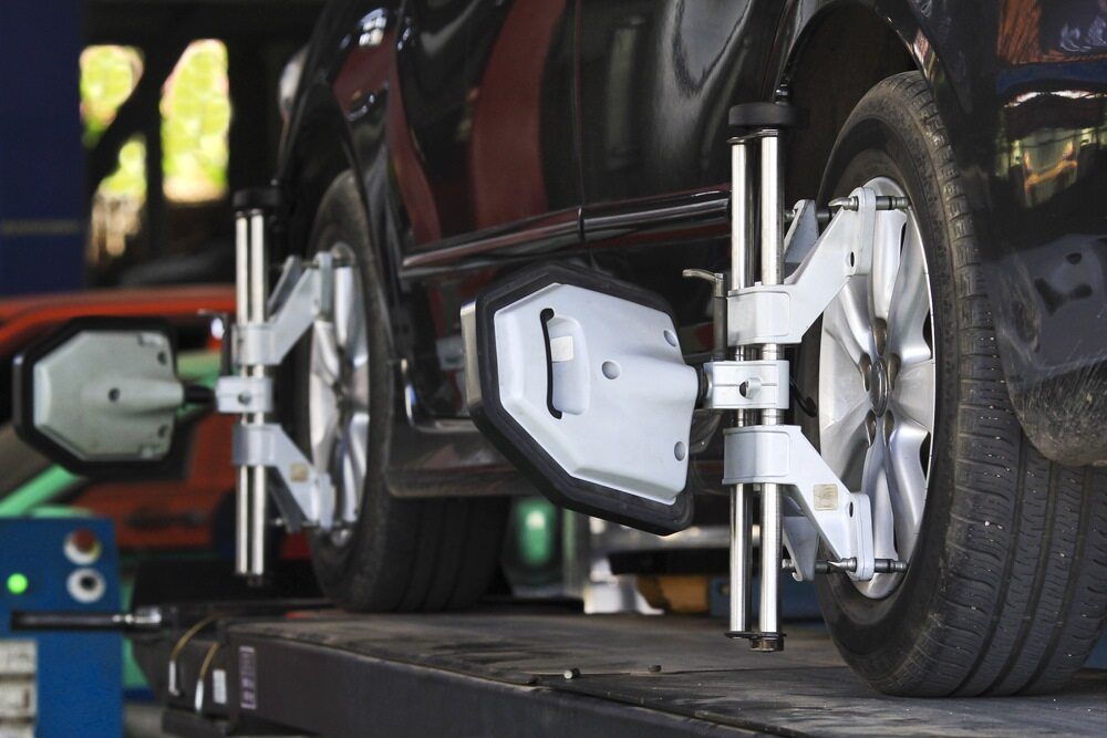 A Car Is Being Aligned With A Machine In A Garage — Superior Machinery Maintenance In Ryan, QLD