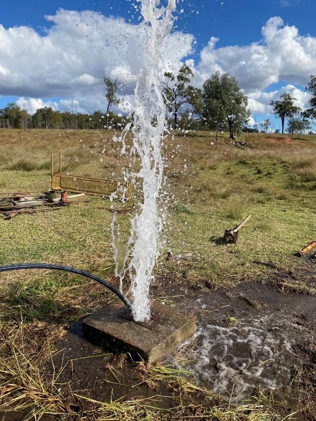Water Gushing From a Concrete Block in a Grassy Field — Local Drilling Services In Kingaroy, QLD
