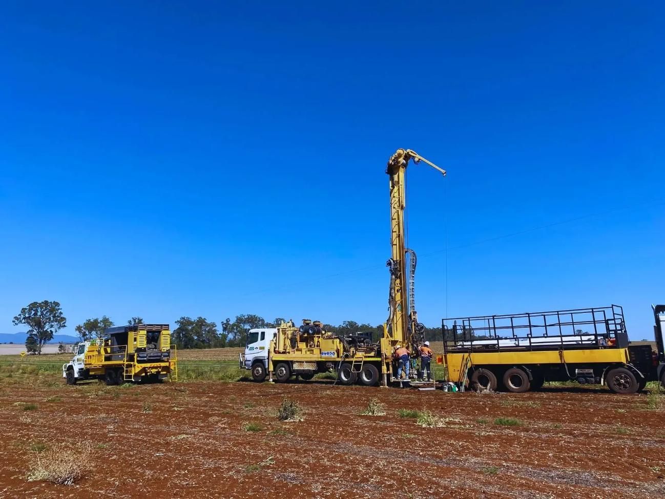 Yellow Drilling Rig in Field Under a Clear Blue Sky — Local Drilling Services In Murgon, QLD