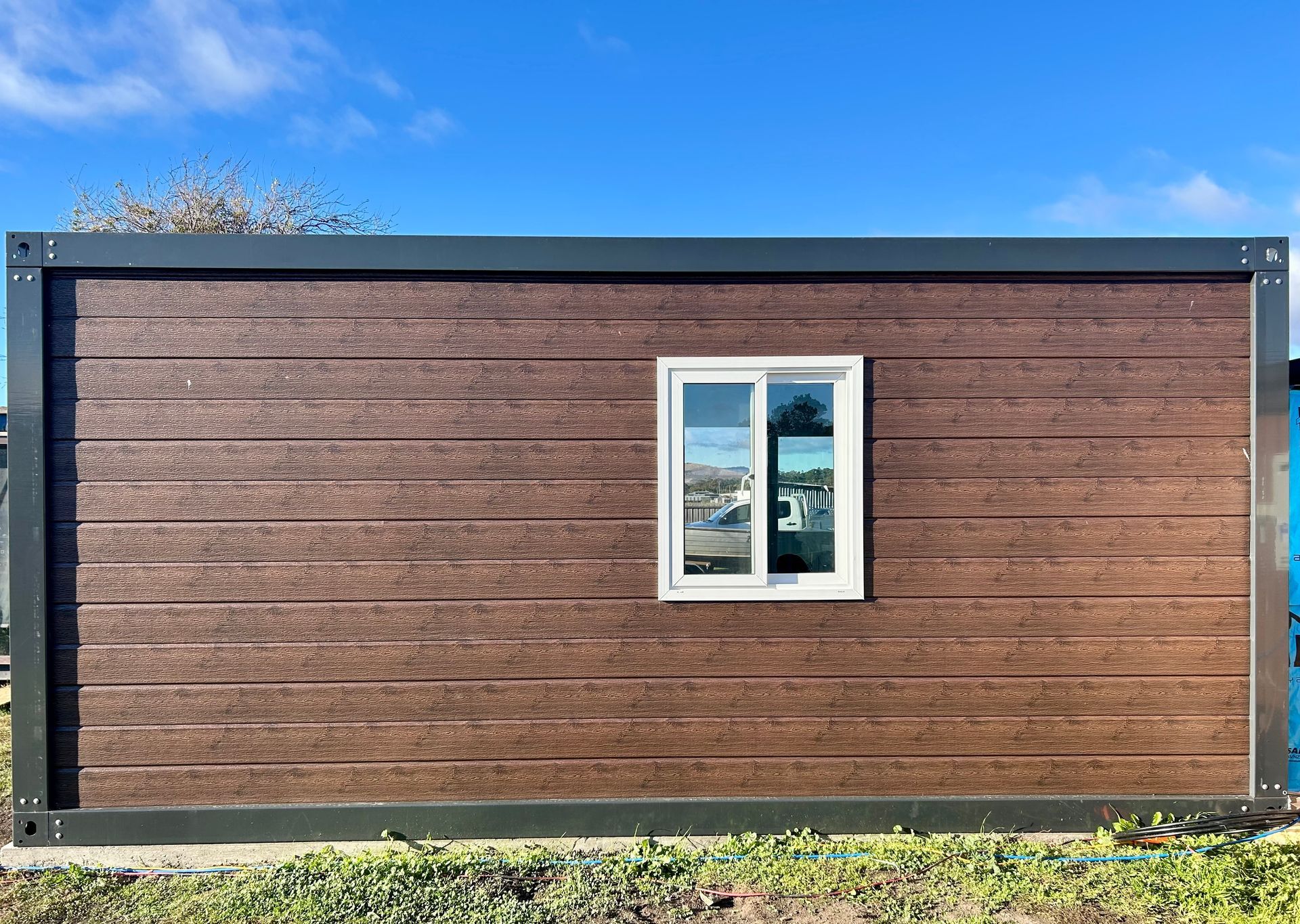 A brown building with a white window on the side