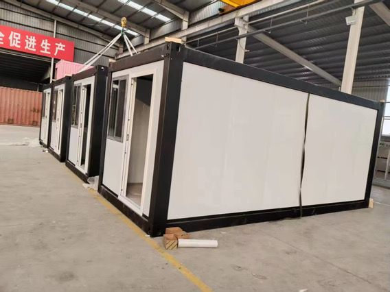 A row of containers are lined up in a warehouse.