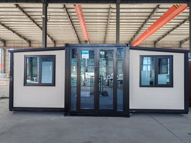 A container house with sliding glass doors and windows in a building.