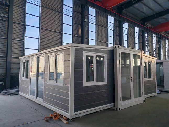 A building with a lot of windows and doors is being built in a factory.