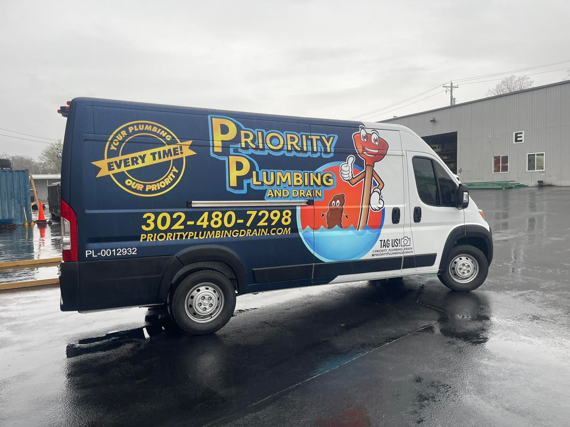 A priority plumbing truck is parked in a parking lot
