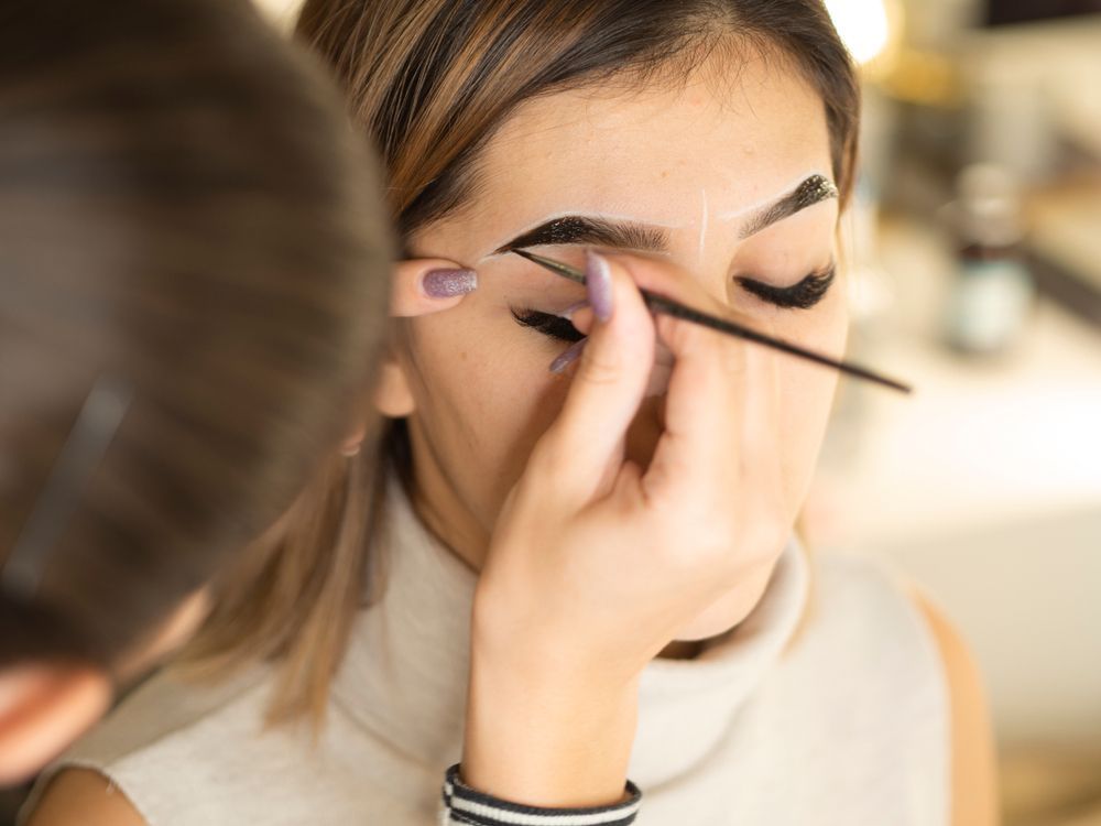Person Having Their Eyebrow Makeup Applied — Oh So Blonde Hair Studio in Buddina, QLD