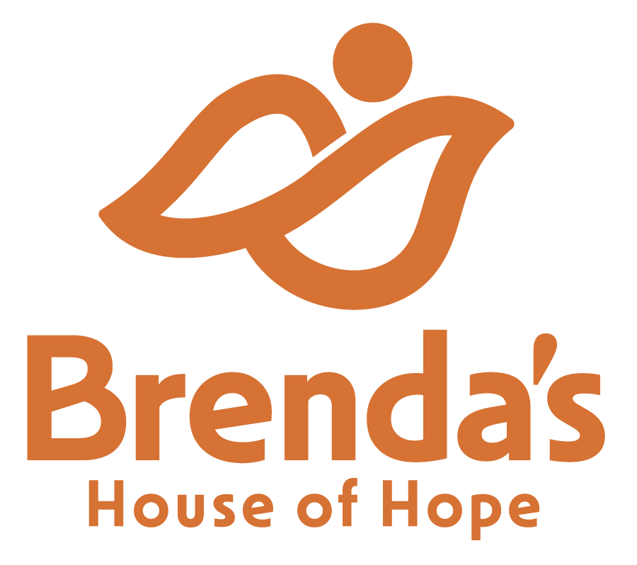 People in yellow shirts, arms linked, forming a circle, viewed from below.