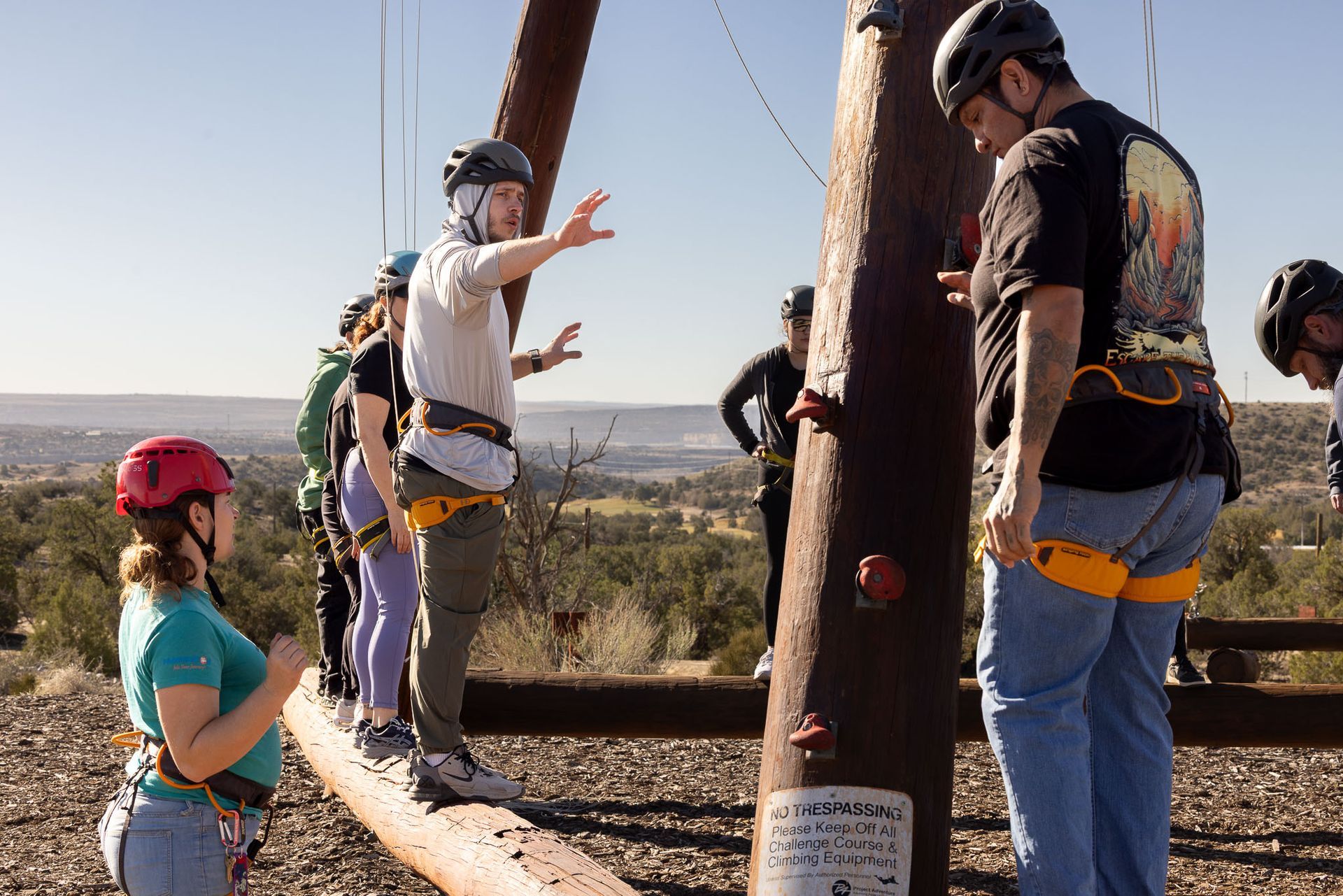Person in hoodie on sofa talking to person in chair; therapy session.