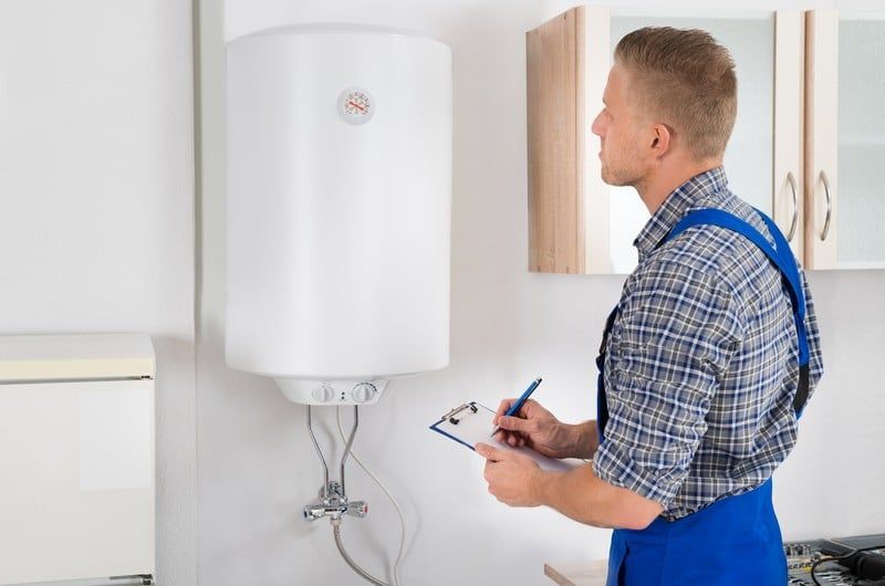 Gas Safe engineer installing a new boiler under finance plan in a London home