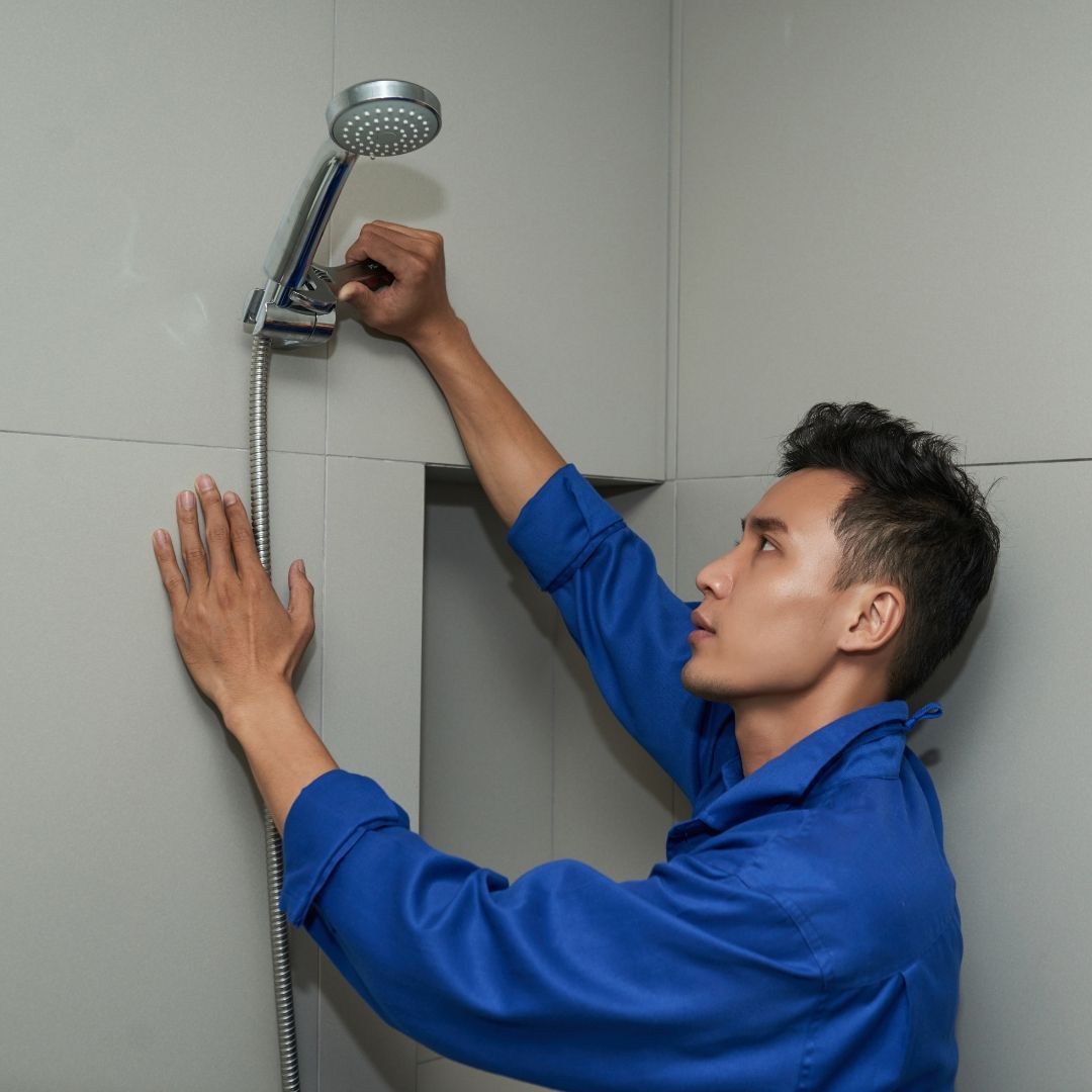 Image of a shower head being repaired by a professional, highlighting the steps involved in fixing c