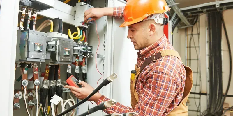 Certified London electrician installing wiring during a home electrical service
