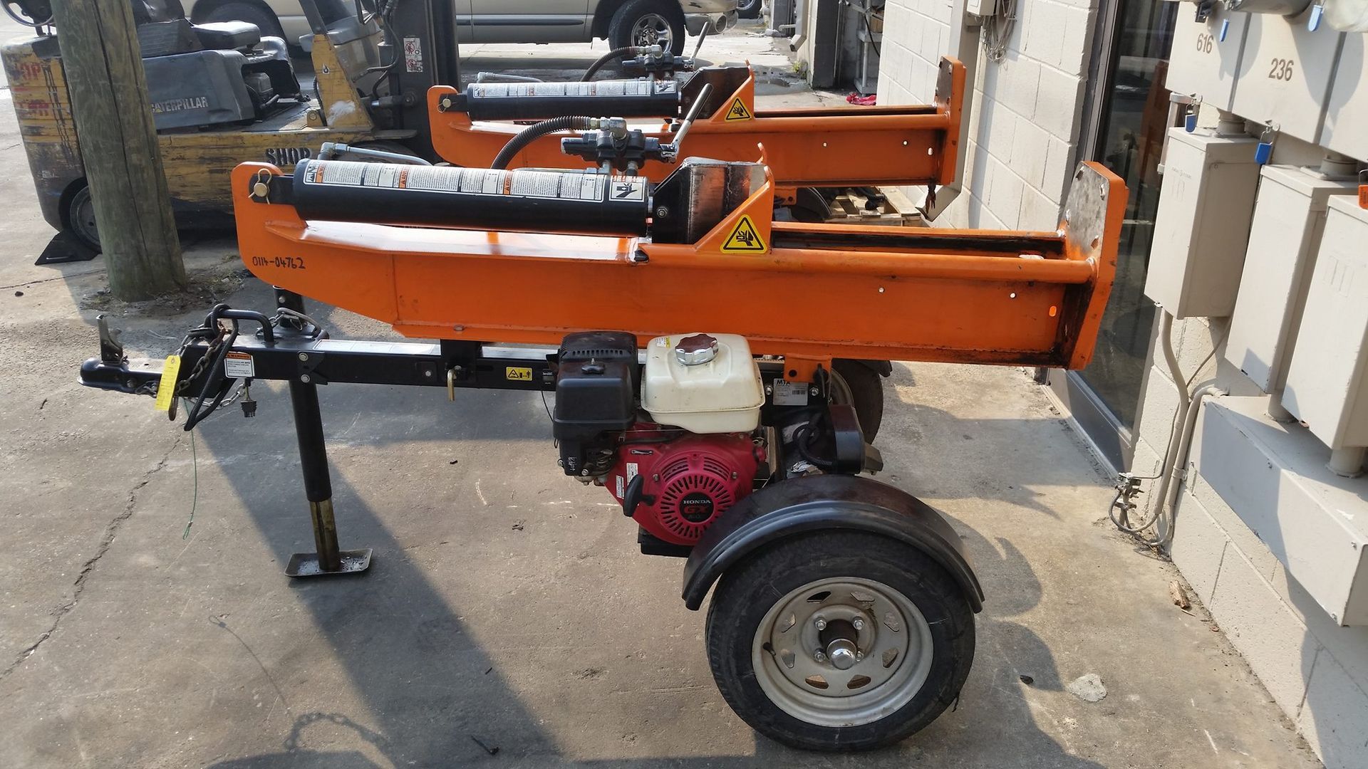 A Log Splitter Is Sitting On A Trailer In A Parking Lot — Lake City, GA — A-1 Hydraulics