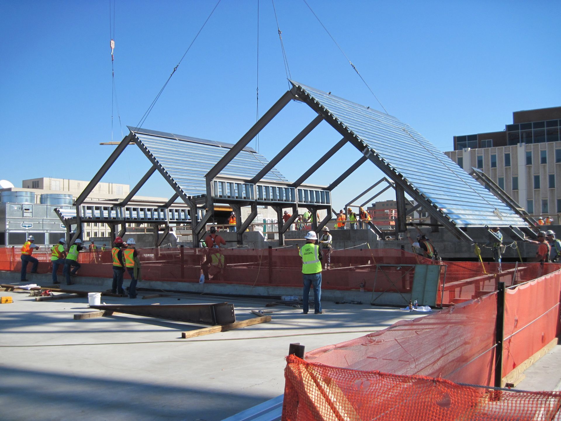A group of construction workers are working on a large structure