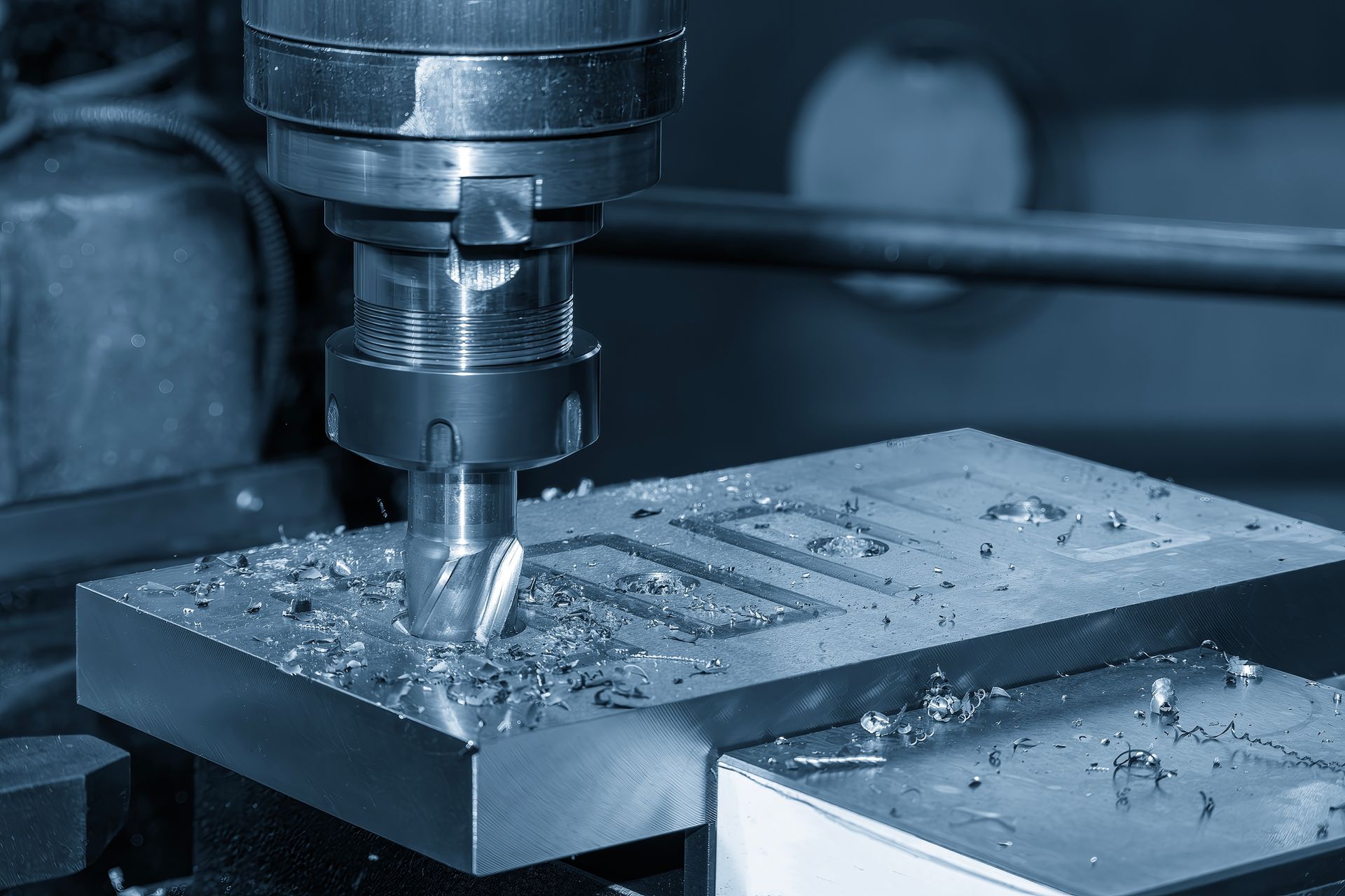 A machine is cutting a piece of metal on a table.