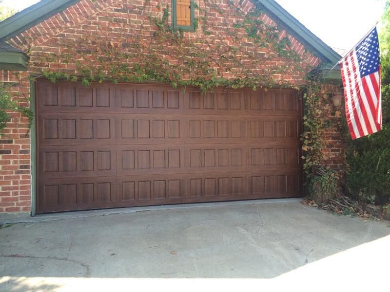 A large brown garage door with an american flag in front of it