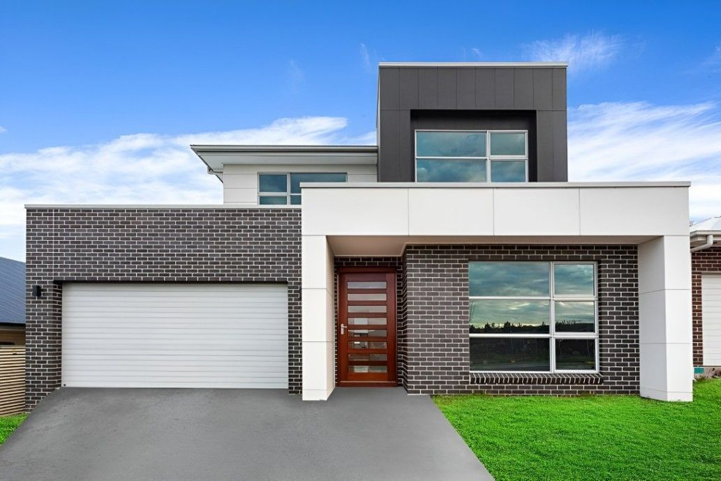 A Modern House With a White Garage Door and a Brick Facade — Let's Paint & Decorate Pty Ltd in Oak Flats, NSW