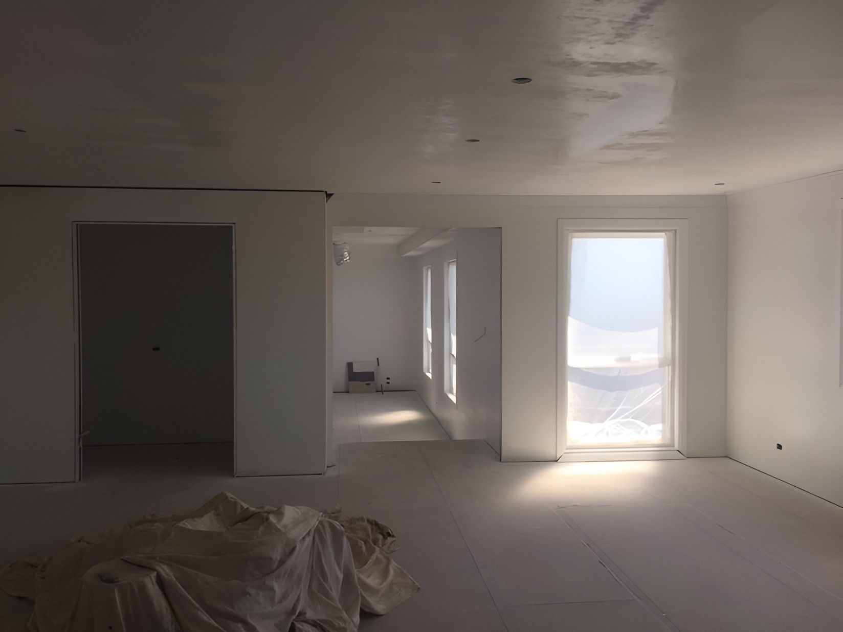 A Large Empty Room With White Walls — Let's Paint & Decorate Pty Ltd in Austinmer, NSW