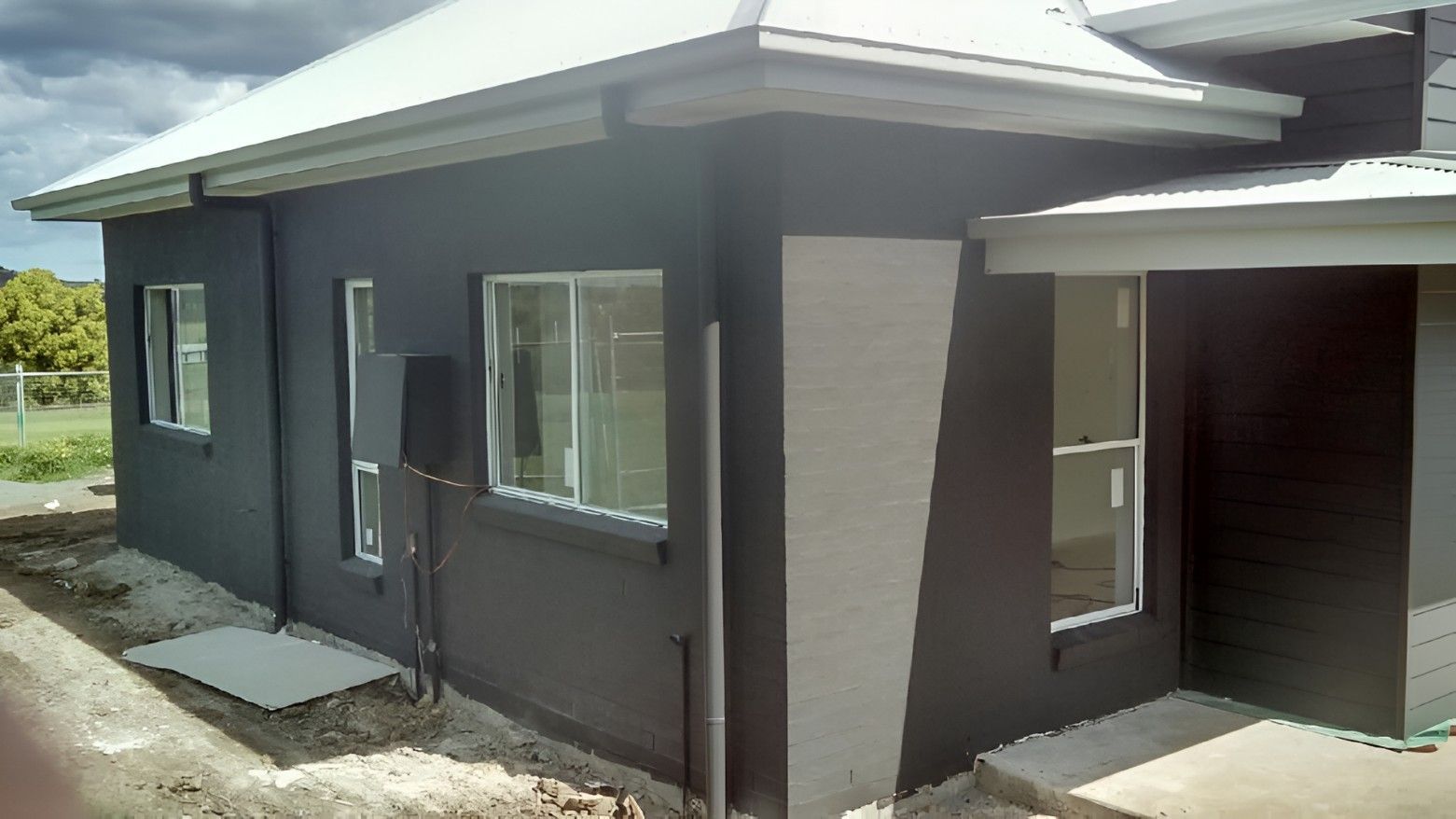 A Black and White House With a White Roof and a Lot of Windows — Let's Paint & Decorate Pty Ltd in Oak Flats, NSW