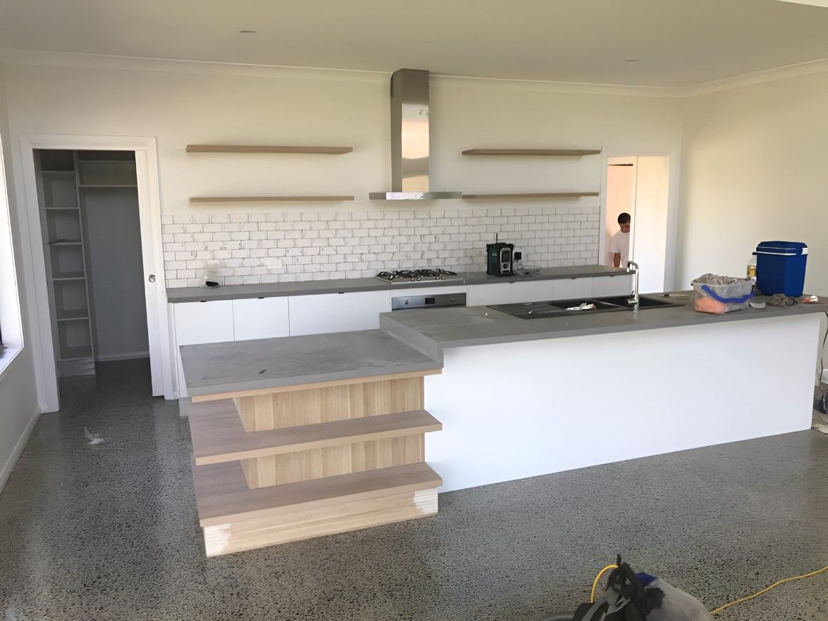 A Kitchen With a Large Island in the Middle of the Room — Let's Paint & Decorate Pty Ltd in Oak Flats, NSW