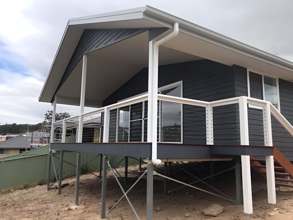 A House on Stilts With a Balcony and Stairs — Let's Paint & Decorate Pty Ltd in Shellharbour, NSW