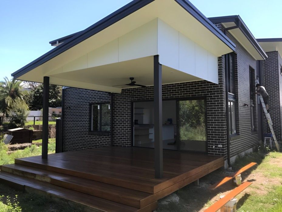A Small House With a Wooden Deck in Front of It — Let's Paint & Decorate Pty Ltd in Bowral, NSW