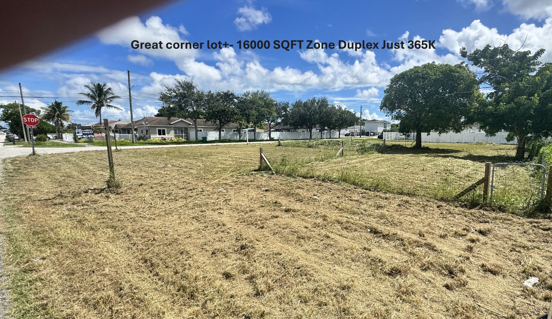 A dining room with a table and chairs and a wooden staircase.