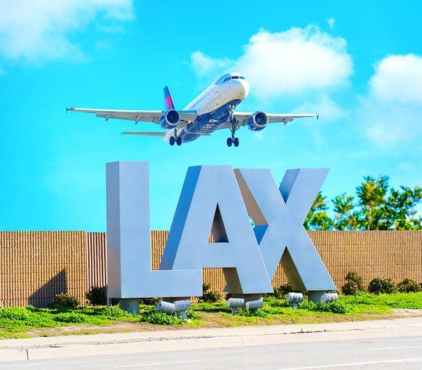 A Delta Air Lines jet flying above the large, silver 
