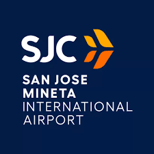 Logo for San Jose Mineta International Airport featuring the letters SJC and an orange, abstract winged icon on navy blue.