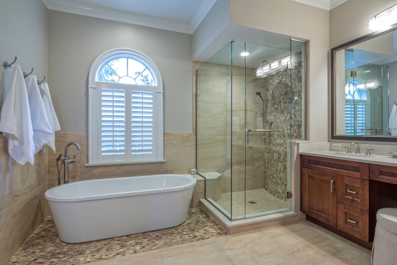 A bathroom with a tub and a walk in shower.