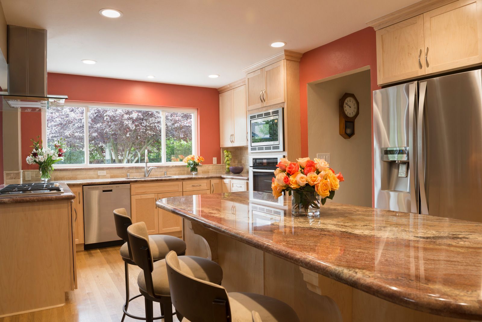 A kitchen with granite counter tops and stainless steel appliances.